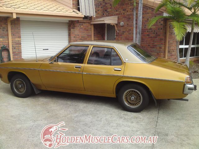 HX Holden in Anniversary Gold Met over Contessa Gold Met — 50th Anniversary Kingswood Sedan