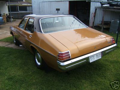 HJ Holden in Sepia Met over Contessa Gold Met — Kingswood Deluxe Sedan