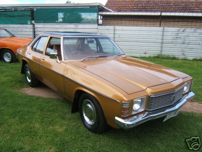HJ Holden in Sepia Met over Contessa Gold Met — Kingswood Deluxe Sedan