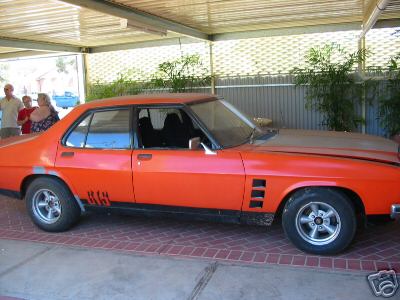 HX Holden in Mandarin Red — Monaro GTS Sedan