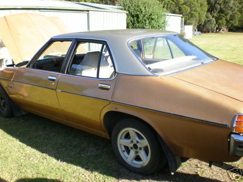 HJ Holden in Antelope Met over Contessa Gold Met — Kingswood Deluxe Sedan