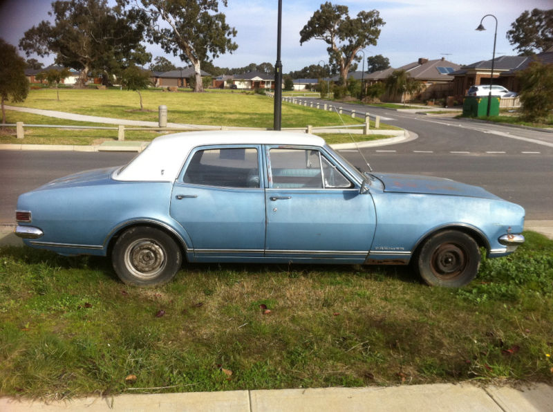 HK Holden in Ermine White over Hacienda Blue Metallic — Premier Sedan